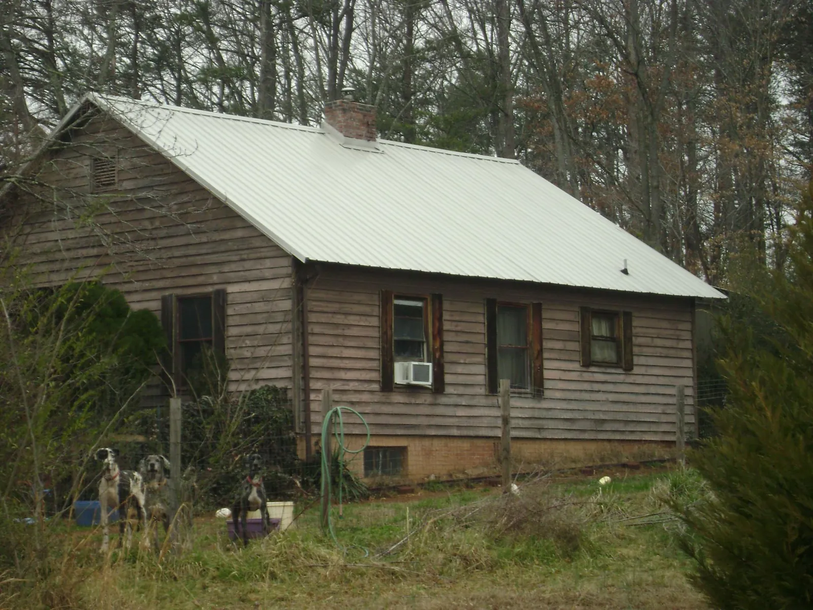 White metal roof on an old wood sided farmhouse, from a Metal Roof Installation job in Marcellus
